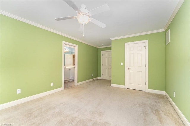 unfurnished bedroom with crown molding, connected bathroom, light colored carpet, and ceiling fan