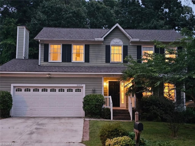 2007 Kildare Woods Dr, Greensboro, NC 27407 - view of front of property featuring driveway, a shingled roof, a chimney, and a front lawn