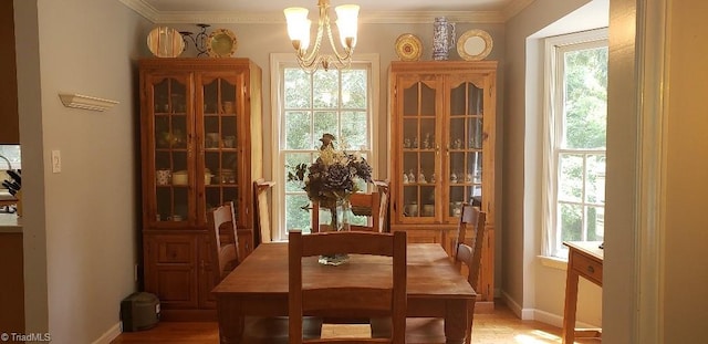 2007 Kildare Woods Dr, Greensboro, NC 27407 - dining room featuring a chandelier, crown molding, light wood finished floors, and baseboards