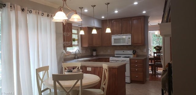 2007 Kildare Woods Dr, Greensboro, NC 27407 - kitchen with white appliances, a sink, decorative backsplash, light countertops, and a peninsula