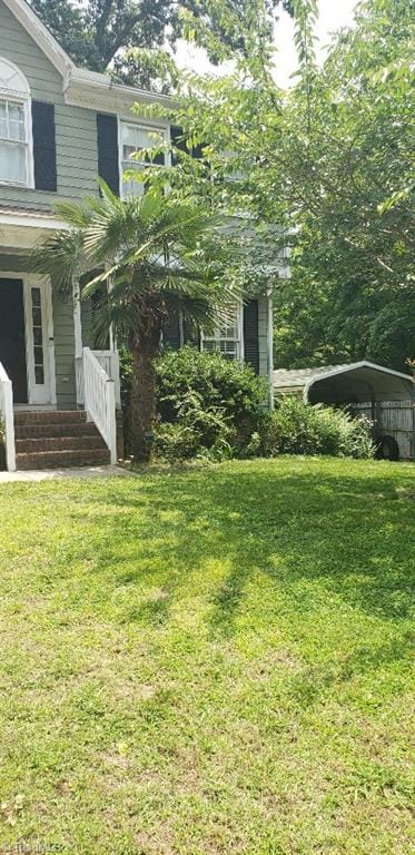 2007 Kildare Woods Dr, Greensboro, NC 27407 - view of green lawn with a detached carport