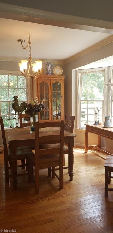 2007 Kildare Woods Dr, Greensboro, NC 27407 - dining area with crown molding, a chandelier, wood-type flooring, and plenty of natural light