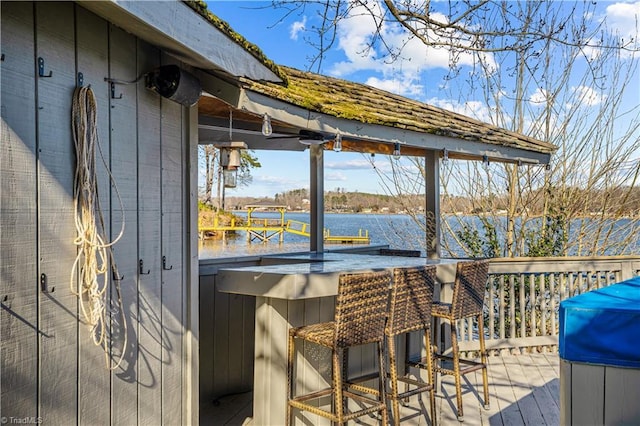 deck featuring a water view and an outdoor bar