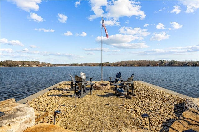 view of dock with a water view and an outdoor fire pit