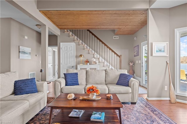 living room with a wealth of natural light, wood ceiling, and hardwood / wood-style flooring