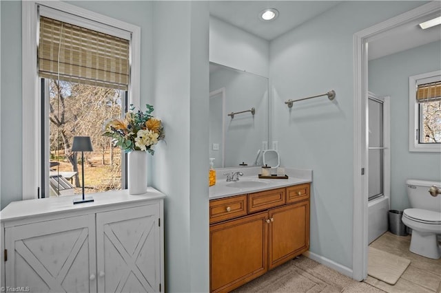 full bathroom featuring shower / bath combination with glass door, vanity, and toilet