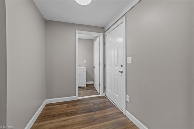 hall with baseboards and dark wood finished floors