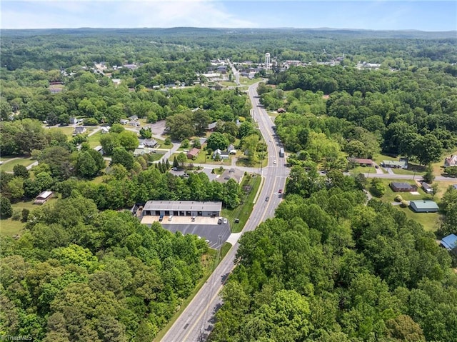 birds eye view of property featuring a wooded view