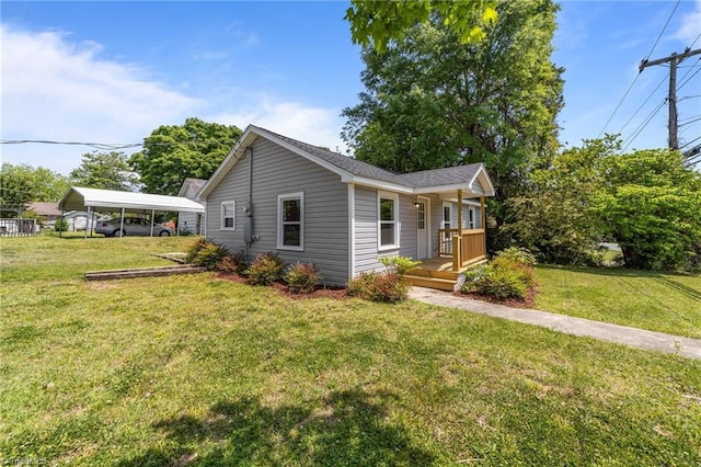 view of front of house with a front yard and a carport