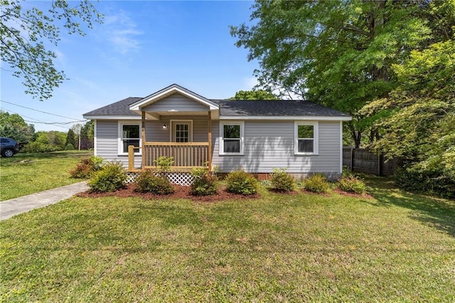 single story home with fence and a front lawn