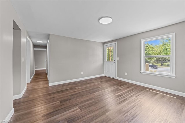 empty room featuring baseboards and wood finished floors