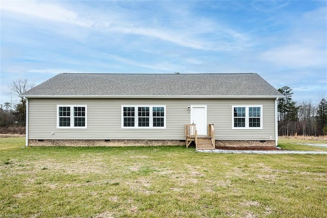 rear view of house featuring crawl space and a lawn