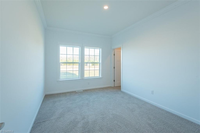 carpeted spare room featuring recessed lighting, baseboards, and ornamental molding