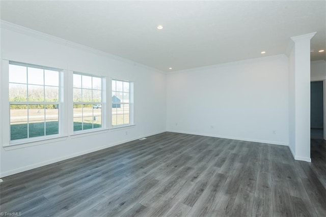 spare room featuring baseboards, ornamental molding, dark wood-style floors, and recessed lighting