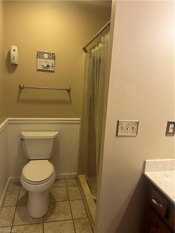 bathroom with vanity, baseboards, tile patterned floors, a shower with curtain, and toilet