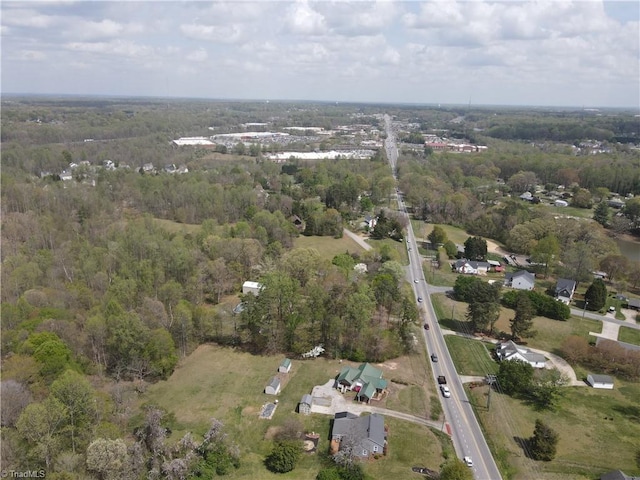 birds eye view of property with a wooded view
