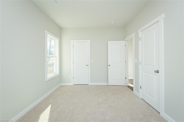 unfurnished bedroom with light carpet