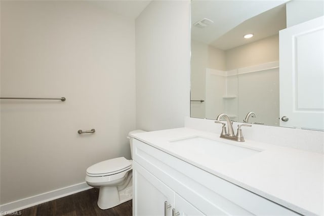 bathroom with vanity, hardwood / wood-style flooring, and toilet