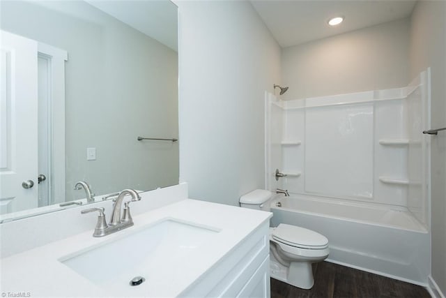 full bathroom featuring vanity, bathtub / shower combination, hardwood / wood-style floors, and toilet