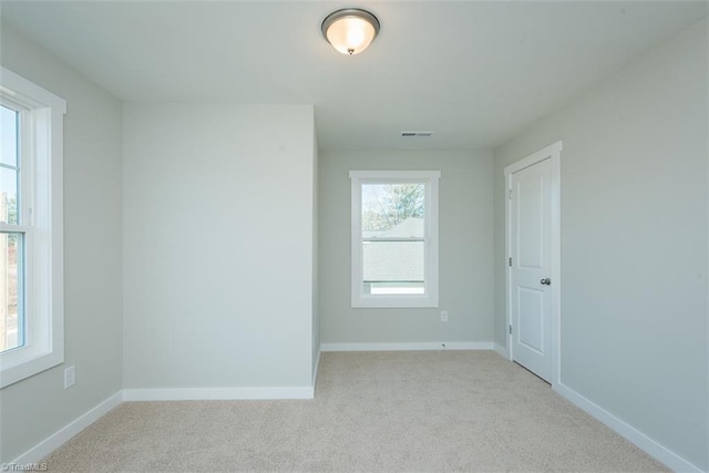 spare room with light carpet