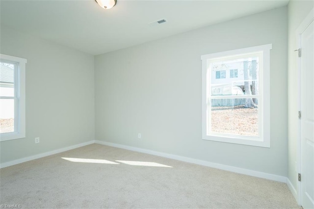 unfurnished room with light carpet