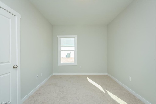 empty room featuring light colored carpet