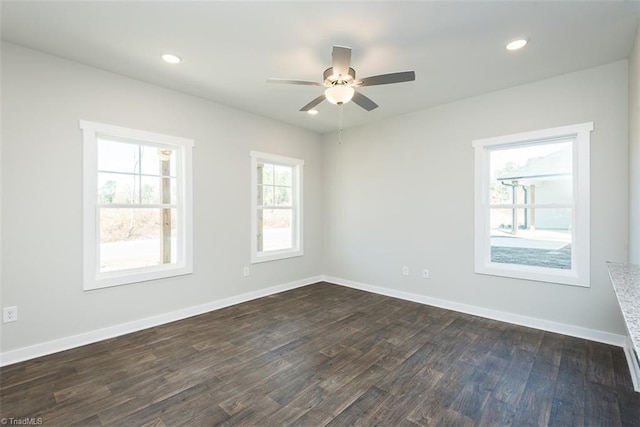 spare room with dark wood-type flooring and ceiling fan