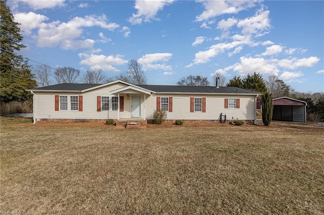 manufactured / mobile home with a front lawn and a carport