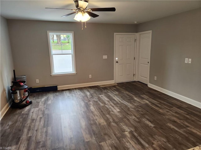 spare room featuring ceiling fan and dark wood-type flooring