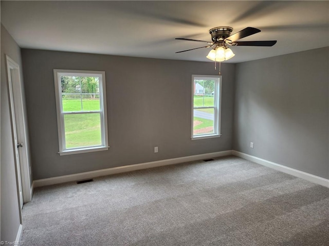 carpeted empty room featuring ceiling fan