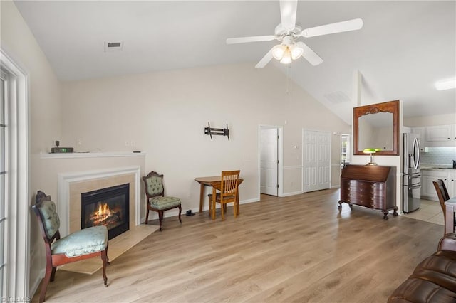 3972 Creekside Ct, Winston-Salem, NC 27127 - living room featuring ceiling fan, lofted ceiling, light wood-style flooring, a fireplace, and baseboards