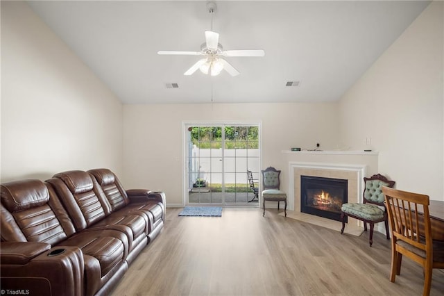 3972 Creekside Ct, Winston-Salem, NC 27127 - living area featuring lofted ceiling, light wood-type flooring, a tiled fireplace, a ceiling fan, and baseboards