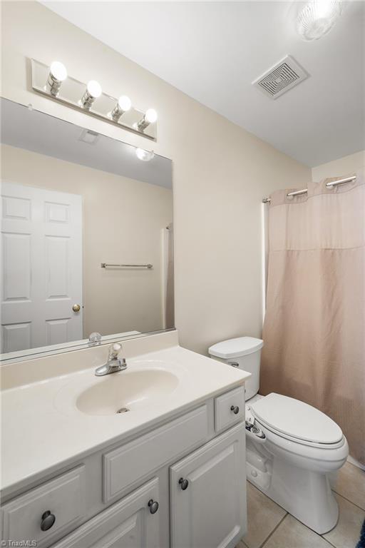 3972 Creekside Ct, Winston-Salem, NC 27127 - bathroom with tile patterned flooring, vanity, toilet, and a shower with shower curtain