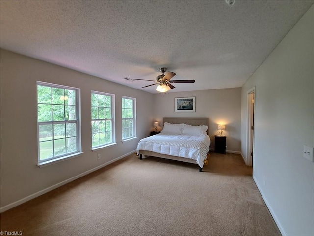 10 Dunlevy Way, Greensboro, NC 27455 - bedroom with light colored carpet, baseboards, a textured ceiling, and a ceiling fan