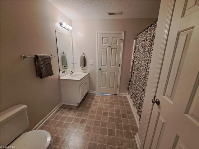 10 Dunlevy Way, Greensboro, NC 27455 - full bath featuring a textured ceiling, toilet, vanity, baseboards, and a shower with shower curtain