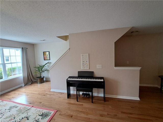 10 Dunlevy Way, Greensboro, NC 27455 - sitting room with a textured ceiling, wood finished floors, and baseboards