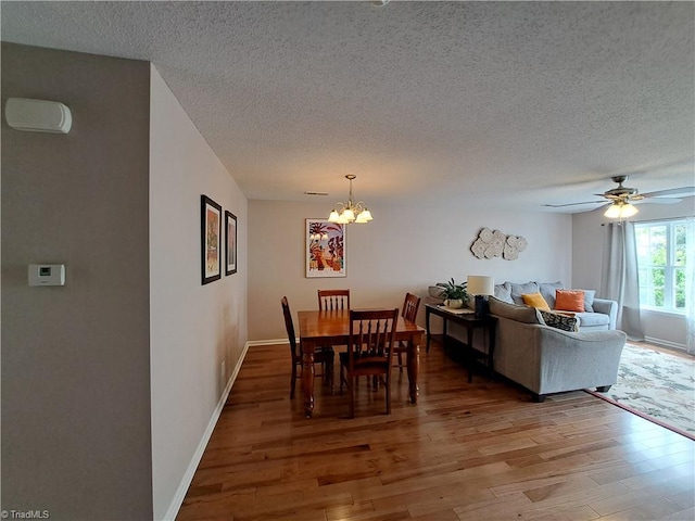 10 Dunlevy Way, Greensboro, NC 27455 - dining area featuring light wood-style floors, a textured ceiling, a chandelier, a ceiling fan, and baseboards