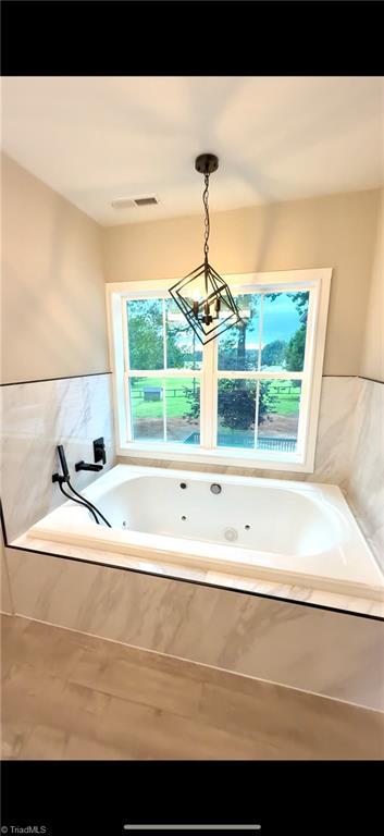 937 Haynes Rd, Summerfield, NC 27358 - bathroom featuring a jetted tub