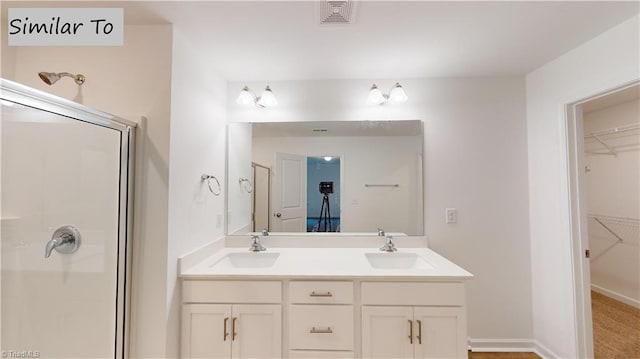 bathroom featuring vanity and a shower with shower door