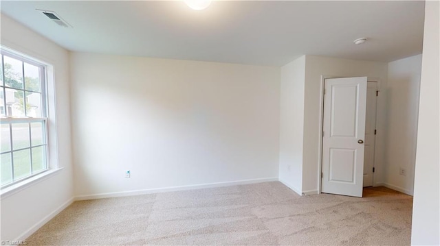 unfurnished room with light carpet