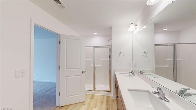 bathroom featuring vanity, wood-type flooring, and an enclosed shower