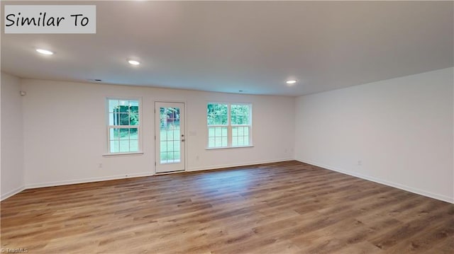 spare room with hardwood / wood-style flooring