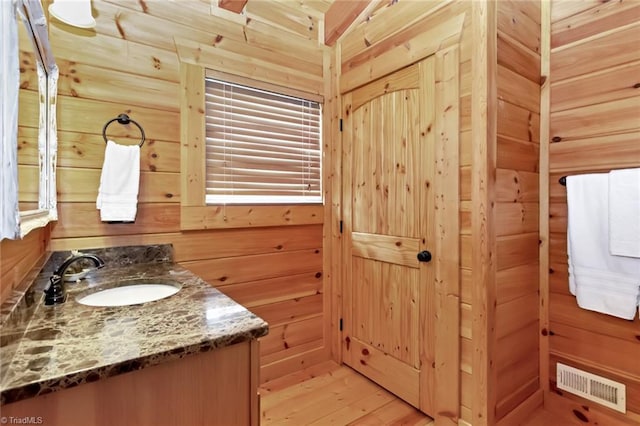 650 Sweetwater Rd, Boomer, NC 28606 - bathroom featuring vanity, wood finished floors, and wooden walls