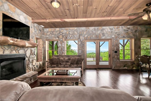 650 Sweetwater Rd, Boomer, NC 28606 - living area with wood ceiling with exposed beams, wood-type flooring, a stone fireplace, and a ceiling fan