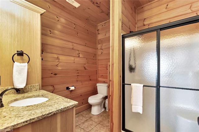650 Sweetwater Rd, Boomer, NC 28606 - bathroom with a stall shower, toilet, tile patterned flooring, vanity, and wooden walls