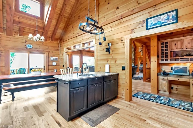 650 Sweetwater Rd, Boomer, NC 28606 - kitchen featuring a sink, wood ceiling with exposed beams, light wood-type flooring, wood walls, and light stone counters