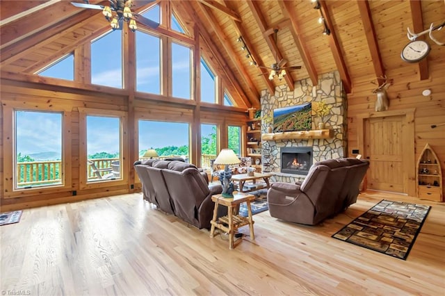 650 Sweetwater Rd, Boomer, NC 28606 - living area featuring a ceiling fan, wood ceiling with exposed beams, a stone fireplace, wood finished floors, and high vaulted ceiling
