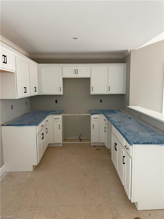 kitchen with white cabinets and crown molding