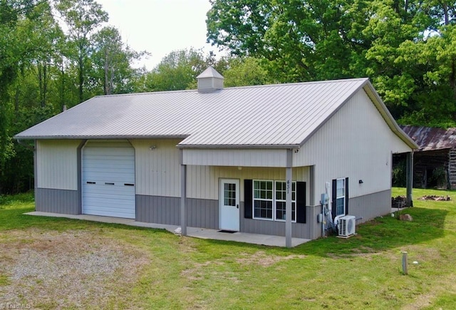 431 Needham Rd, Pilot Mountain, NC 27041 - rear view of house with a detached garage, a yard, metal roof, a chimney, and driveway