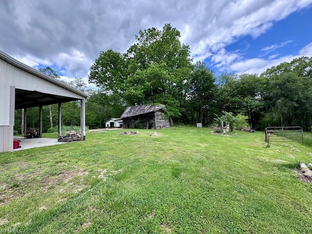 431 Needham Rd, Pilot Mountain, NC 27041 - view of green lawn featuring an outdoor structure and a patio